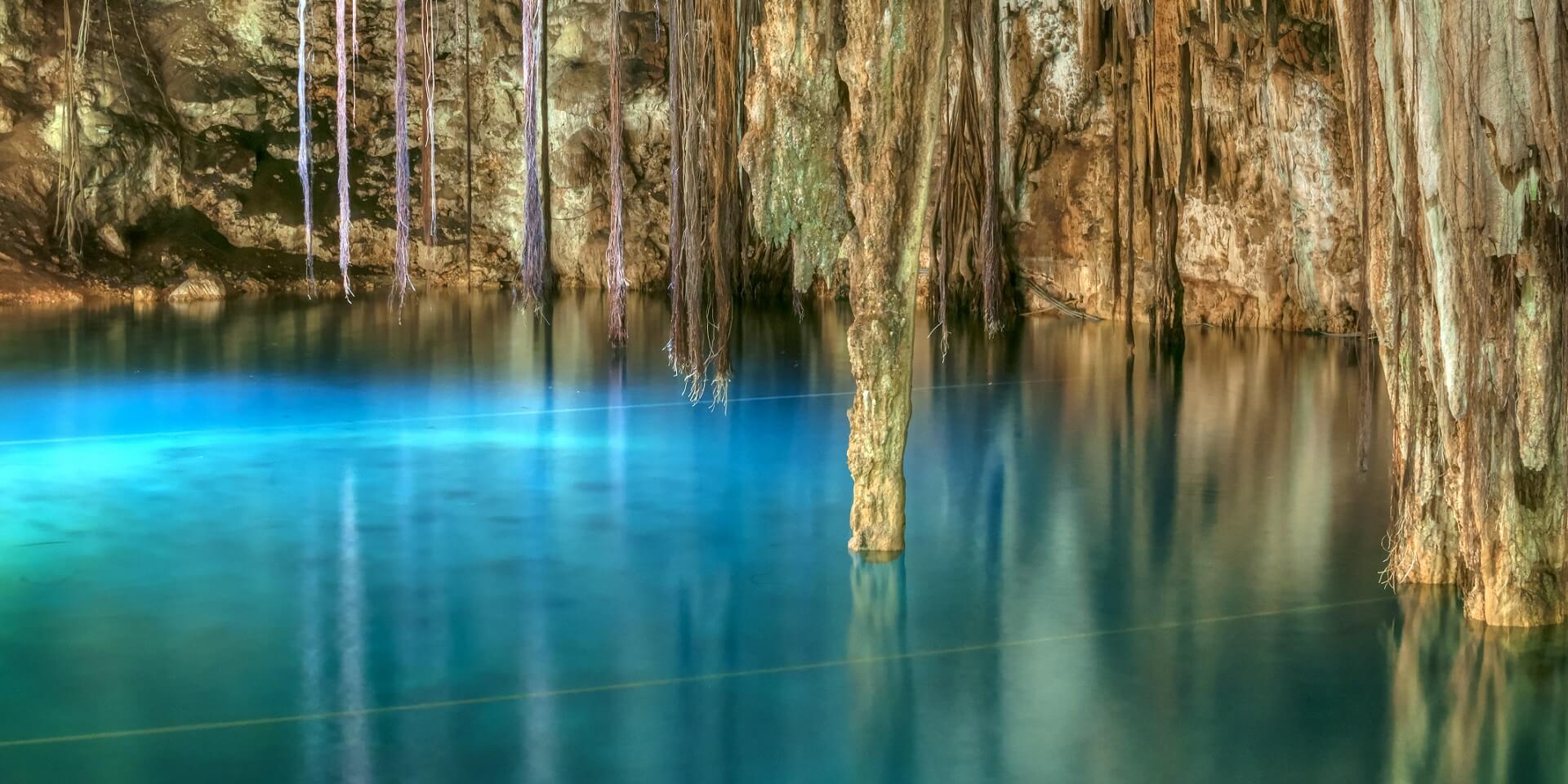Footer Beautiful clear blue water of Xkenken cenote in Dzitnup, Mexico