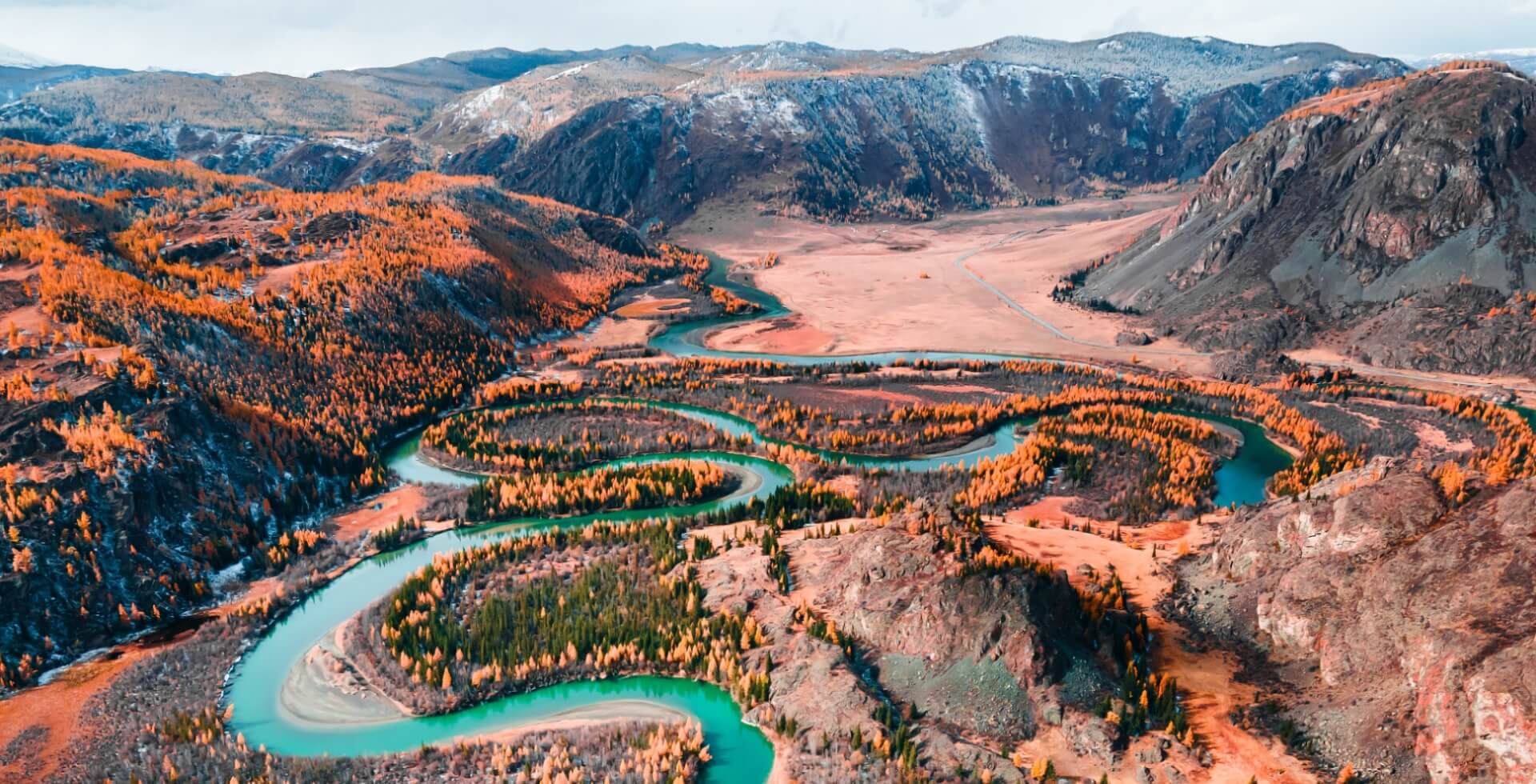 Footer Chuya river in Altai mountains, Siberia, Russia. Aerial view. Blue river with yellow autumn trees in the mountains at sunset. Autumn landscape.