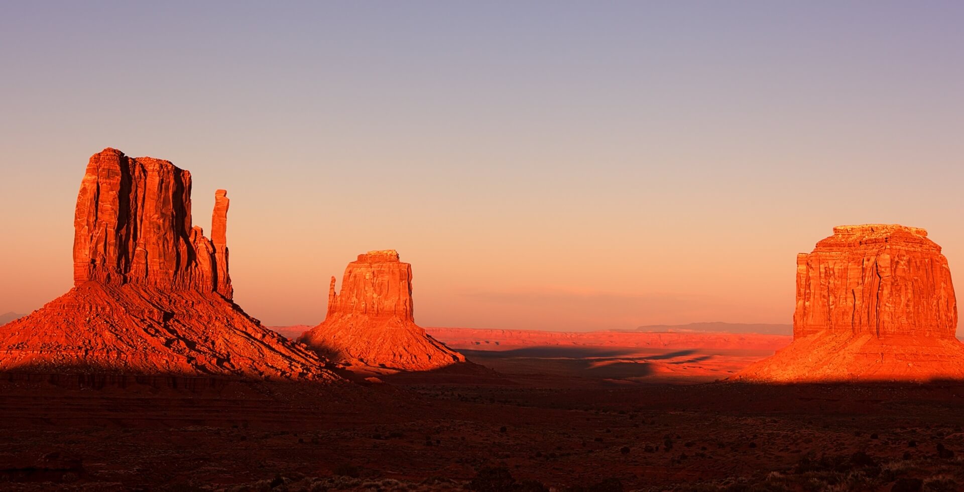 Footer Mitten Buttes of Monument Valley at sunset, Utah, USA